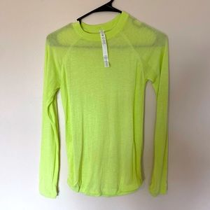 Neon highlighter yellow Lululemon sweater.